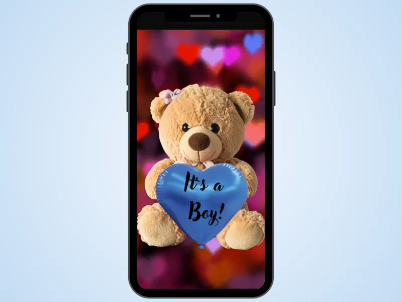 Teddy bear gender reveal scratch card on a phone over a soft blue background, heart balloon scratched to reveal It's a Boy