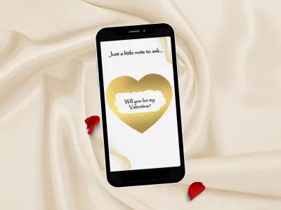 Valentine scratch card on a phone lying on cream satin with rose petals, gold heart scratched to reveal Will you be my Valentine
